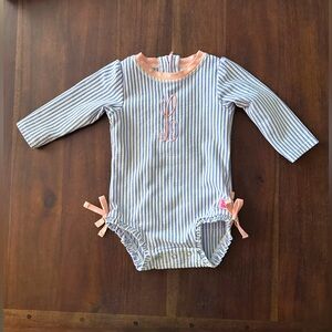 Ruffle Butts seersucker one piece rash guard with cursive L embroidered
